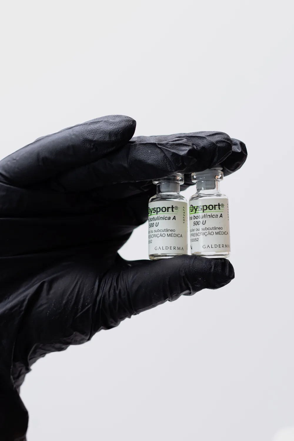 Insumo inyectable de uso médico sostenido con guante estéril antes de la aplicación